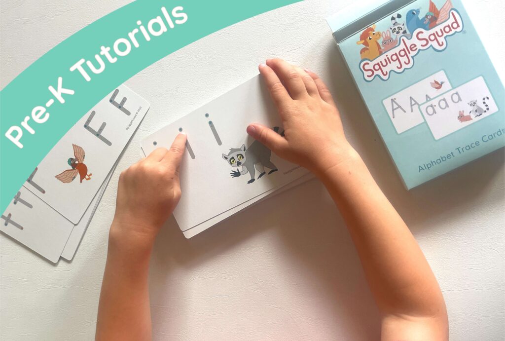 Child's hands using alphabet trace cards on a table, with a box labeled "Squiggle Squad Alphabet Trace Cards" and text "Pre-K Tutorials" in the corner.