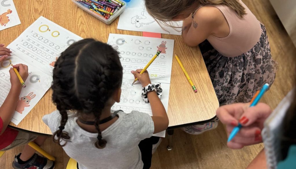 2 kids using Squiggle Squad student booklets